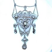 AN ANTIQUE BELLE EPOQUE RUSSIAN DIAMOND PENDANT NECKLACE IN THE ART NOUVEAU OPEN WORK STYLE WITH