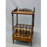 A VICTORIAN WALNUT CANTERBURY TABLE, THE TOP WITH THREE QUARTER PIERCED GALLERY ABOVE BARLEY TWIST