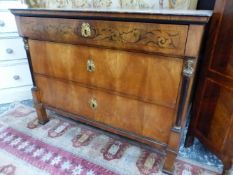 A 19th C. BIEDERMEIER SATIN WOOD CHEST OF THREE GRADED LONG DRAWERS BETWEEN EBONISED COLUMNS TOPPED