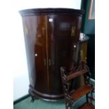 A MAHOGANY BOW FRONT CORNER CUPBOARD WITH THREE CABRIOLE LEGS ON PAD FEET. W 75.5 x H 133.5cms.