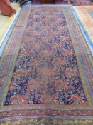 AN ANTIQUE PERSIAN COUNTRY HOUSE GALLERY CARPET. 455 x 207cms
