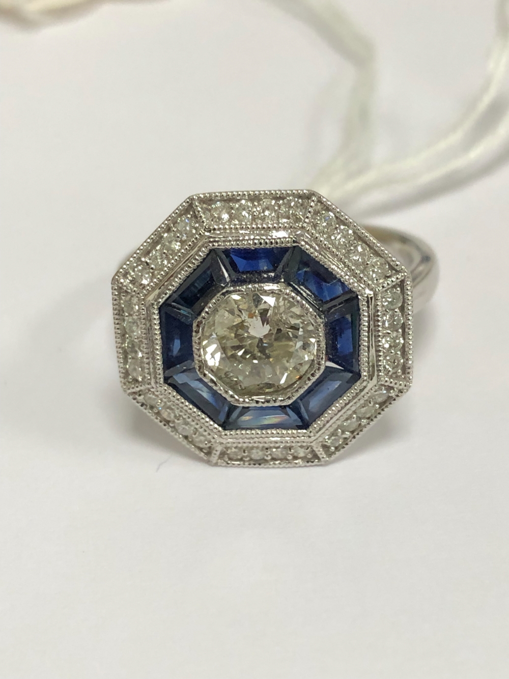 A PLATINUM HALLMARKED SAPPHIRE AND DIAMOND TARGET RING. THE CENTRAL DIAMOND APPROX DIAMETER 6.2mm. - Image 6 of 6