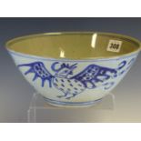 A PROVINCIAL CHINESE BLUE AND WHITE BOWL, THE EXTERIOR PAINTED WITH TWO ROOSTERS ALTERNATING WITH
