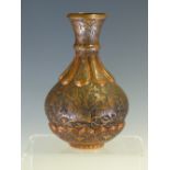 A 19th C. INDIAN COPPER BOTTLE INCISED WITH A HUNTING SCENE BETWEEN LOBES ENGRAVED WITH FLOWERS. H