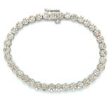 A 9ct WHITE GOLD HALLMARKED DIAMOND MULTI CLUSTER TENNIS BRACELET. APPROX DIAMOND WEIGHT AS STATED