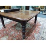 A VICTORIAN MAHOGANY DINING TABLE EXTENDING TO TAKE THREE LEAVES, THE ROUNDED RECTANGULAR TOP WITH