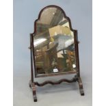 A MAHOGANY DRESSING TABLE MIRROR, THE OGEE ARCHED PLATE SUPPORTED ON COLUMNS WITH