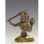 A NEPALESE COPPER FIGURE OF MANJUSHRI SEATED CROSS LEGGED WITH A FLAME TIPPED SWORD IN HIS RIGHT