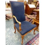 A FRENCH WALNUT ARMCHAIR THE BACK AND SEAT UPHOLSTERED IN BLUE, THE ARMS AND CABRIOLE LEGS CARVED