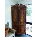 AN EARLY 19TH CENTURY MAHOGANY AND MARQUETRY INLAID BOW FRONT CORNER CABINET.