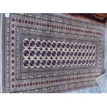 AN ORIENTAL RUG OF BOKHARA DESIGN. 180 x 130cms