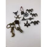 A COLLECTION OF VARIOUS METAL PENDANTS, TO INCLUDE: SEALS, HORSES, BARBED PENDANTS AND A WHEEL