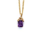 AN EMERALD CUT AMETHYST AND DIAMOND SET PENDANT, STAMPED 14K, 585 ASSESSED AS 14ct GOLD SUSPENDED ON