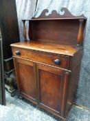 AN EARLY VICTORIAN MAHOGANY CHIFFONIER WITH RAISED GALLERY OVER TWO PANEL DOORS ENCLOSING DRAWERS