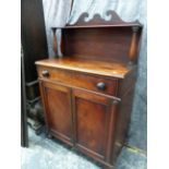 AN EARLY VICTORIAN MAHOGANY CHIFFONIER WITH RAISED GALLERY OVER TWO PANEL DOORS ENCLOSING DRAWERS