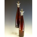 A PAIR OF VICTORIAN AUBERGINE GLASS WINE CARAFES AND STOPPERS SILVER MOUNTED BY REILLY AND STORER,