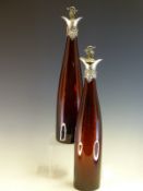A PAIR OF VICTORIAN AUBERGINE GLASS WINE CARAFES AND STOPPERS SILVER MOUNTED BY REILLY AND STORER,