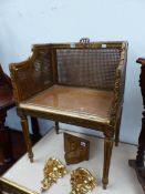 AN ANTIQUE GILT WOOD FRAMED CANE SEAT AND BACK, DRESSING STOOL/CHAIR