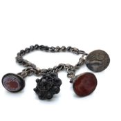 AN ANTIQUE HALLMARKED SILVER ROLLERBALL BRACELET WITH THREE SILVER SEAL FOBS, TWO WITH HARDSTONE