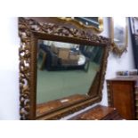 A 19th C. ITALIANTE RECTANGULAR MIRROR, THE GILT FRAME PIERCED AND CARVED WITH FOLIAGE. 83 x 115cms.