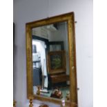 AN EARLY 19th C. FRENCH RECTANGULAR MIRROR WITHIN A GILT FRAME WITH FOLIAGE MOULDINGS AT THE CORNERS