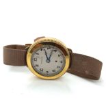 AN ANTIQUE HARWOOD SELF WINDING AUTOMATIC WRIST WATCH ON A MILITARY TYPE STRAP. THE CASE 18ct GOLD