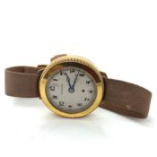 AN ANTIQUE HARWOOD SELF WINDING AUTOMATIC WRIST WATCH ON A MILITARY TYPE STRAP. THE CASE 18ct GOLD