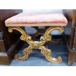 A MID VICTORIAN CARVED WALNUT X FRAME STOOL.