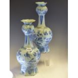 A PAIR OF 18th C. DUTCH DELFT BLUE AND WHITE ONION TOPPED BOTTLE VASES PAINTED WITH BIRDS AND