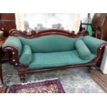 A VICTORIAN MAHOGANY SHOW FRAME SETTEE, THE BACK AND ARM FRONTS CARVED WITH S-SHAPED SCROLLS, THE