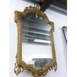 A 19th C. MIRROR, THE SHIELD SHAPE WITHIN A GILT FRAME CRESTED BY RIBBON TIED LAUREL AND WITH BEAD