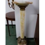 AN ORMOLU MOUNTED ONYX COLUMN PEDESTAL WITH A SQUARE TOP ON THE CYLINDRICAL COLUMN SUPPORTED ON CANT