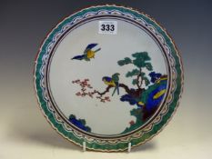 A JAPANESE GREEN KUTANI DISH CENTRALLY PAINTED WITH THREE BIRDS ABOUT A CHERRY BLOSSOM BRANCH,