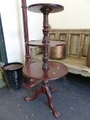 A MAHOGANY THREE TIER DUMB WAITER ON CARVED TRIPOD SUPPORTS