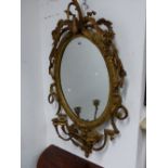 A LATE 19th C. OVAL GIRANDOLE MIRROR CRESTED WITH BIRDS AND FOLIAGE AND WITH THREE CANDLE