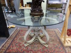 AN INTERESTING MID CENTURY CAST ALLOY AND GLASS TABLE- THE BASE CAST TO SIMULATE BENTWOOD IN THE