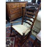 A 19th CENTURY LANCASHIRE LADDER BACK ROCKING CHAIR.