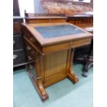 A LATE VICTORIAN OAK DAVENPORT DESK