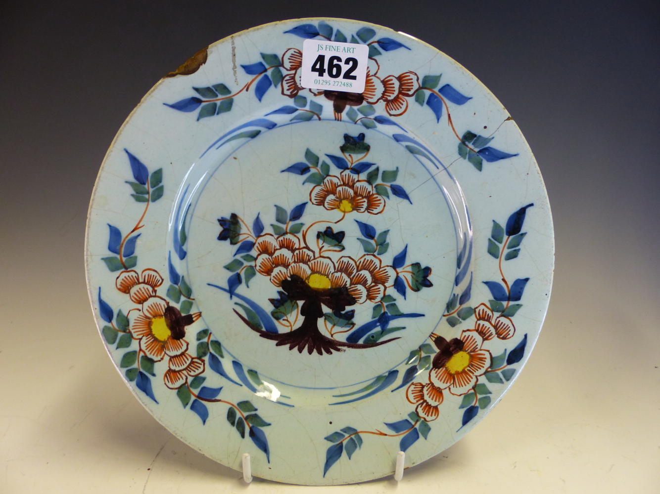 A PAIR OF 18th C. ENGLISH DELFT POLYCHROME PLATES PAINTED WITH YELLOW CENTRED RED FLOWERS WITHIN