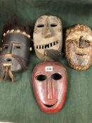 THREE NEPALESE CARVED WOODEN MASKS TOGETHER WITH A YAO WOODEN MASK, THE LARGEST MOUNT WITH HAIR