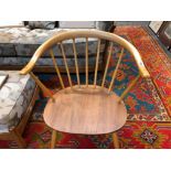 A PAIR OF ERCOL PALE ELM ARMCHAIRS