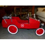 A RED PAINTED CHILDS FIRE DEPARTMENT PEDAL CAR WITH A BELL ON THE BONNET AND A 1938 NUMBER PLATE