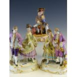 A MEISSEN GROUP OF AN 18th C. COUPLE DANCING PAIRED WITH A COUPLE WALKING. H 9cms. TOGETHER WITH