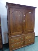 A 19th OAK LINEN PRESS WITH PANELLED DOORS OVER TWO BANKS OF TWO SHORT DRAWERS. W 135 x D 52 x H