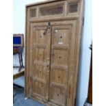 A PAIR OF AFGHAN FOUR PANELLED DOORS WITHIN A FRAME CRESTED BY THREE MISHRABIYE PANELS. 248 x