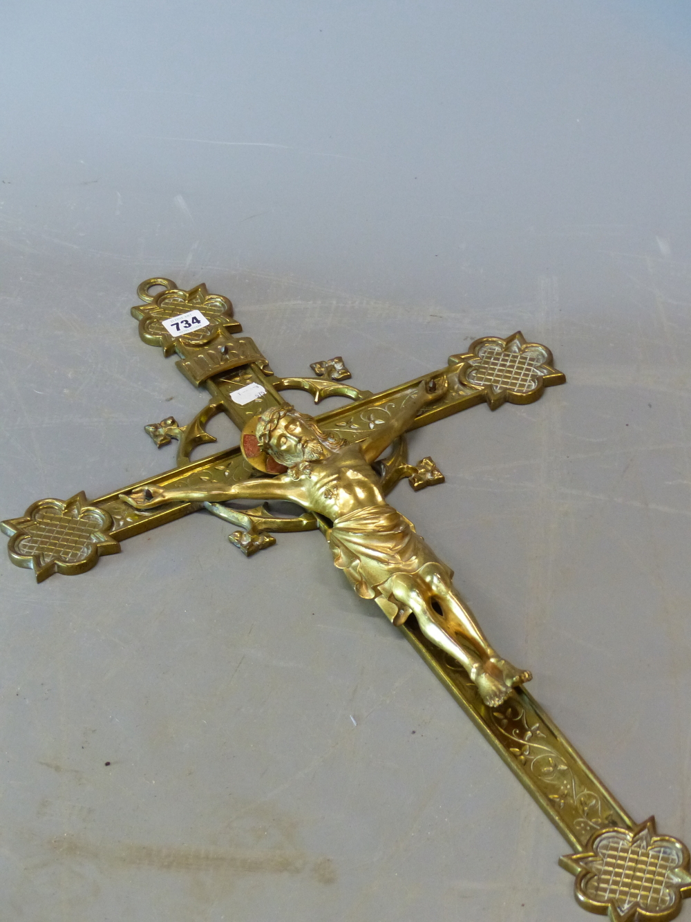 A LATE 19th C. GILT BRONZE CRUCIFIX, CHRISTS HALO PICKED OUT IN RED, THE END OF THE CROSS WITH