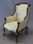 A FRENCH STYLE VICTORIAN MAHOGANY SHOW FRAME WING ARMCHAIR CRESTED BY PAIRS OF SCROLLS AND FOLIAGE,