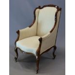 A FRENCH STYLE VICTORIAN MAHOGANY SHOW FRAME WING ARMCHAIR CRESTED BY PAIRS OF SCROLLS AND FOLIAGE,