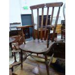 AN ANTIQUE SLAT BACK KITCHEN ARM CHAIR.