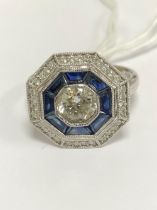 A PLATINUM HALLMARKED SAPPHIRE AND DIAMOND TARGET RING. THE CENTRAL DIAMOND APPROX DIAMETER 6.2mm.
